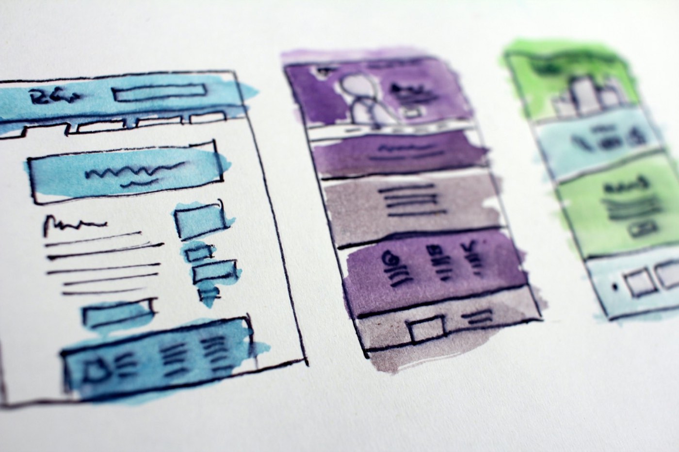 Watercolor sketches of several website screens before the design phase