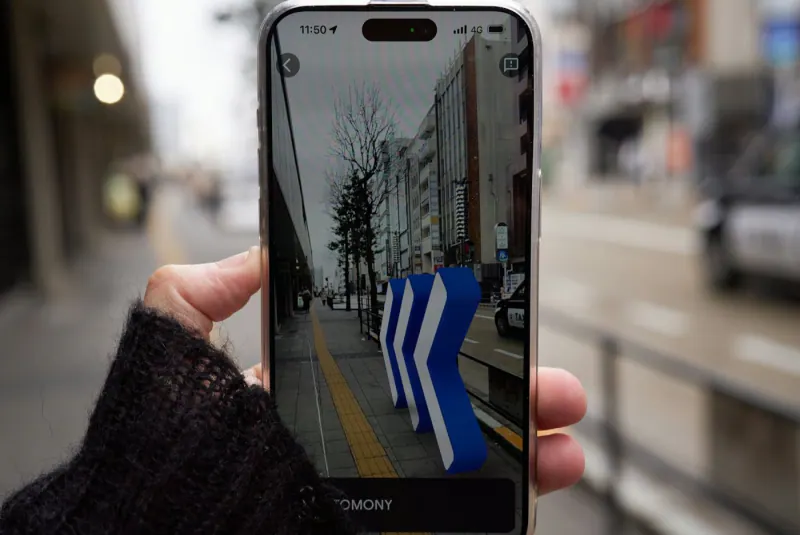 Person holding a phone with a map navigation app on a city street