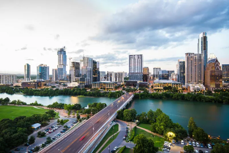 Aerial view of the Austin skyline and Congress Avenue Bridge at sunset