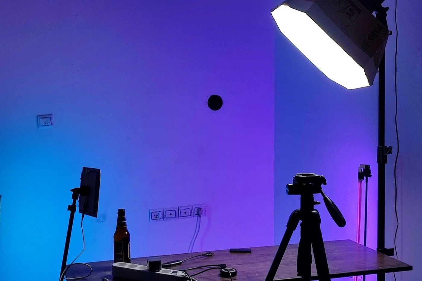 Small home studio with a softbox light, tripod and a table set up for product photos