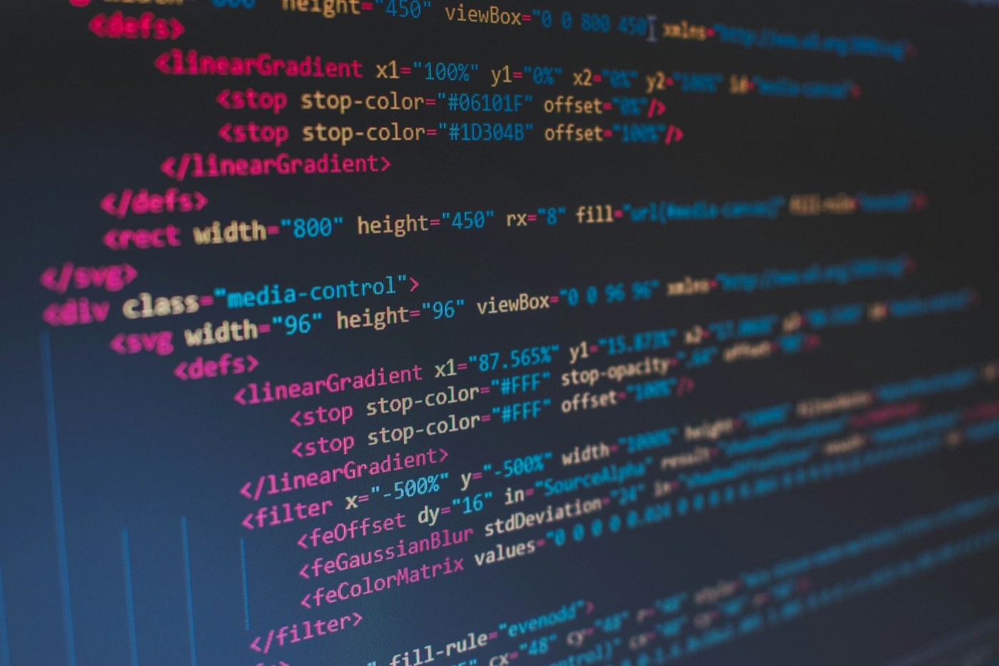 Screen showing colorful lines of HTML code on a dark background