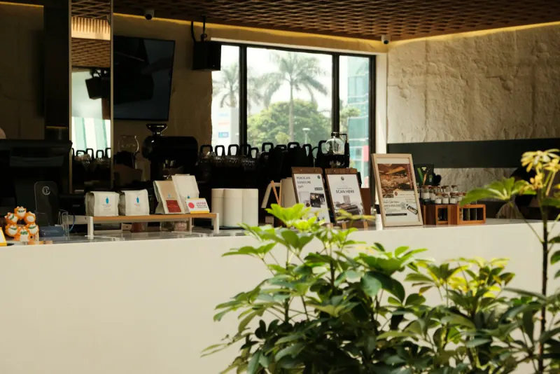 Counter of a modern café with plants, ready to serve regular customers